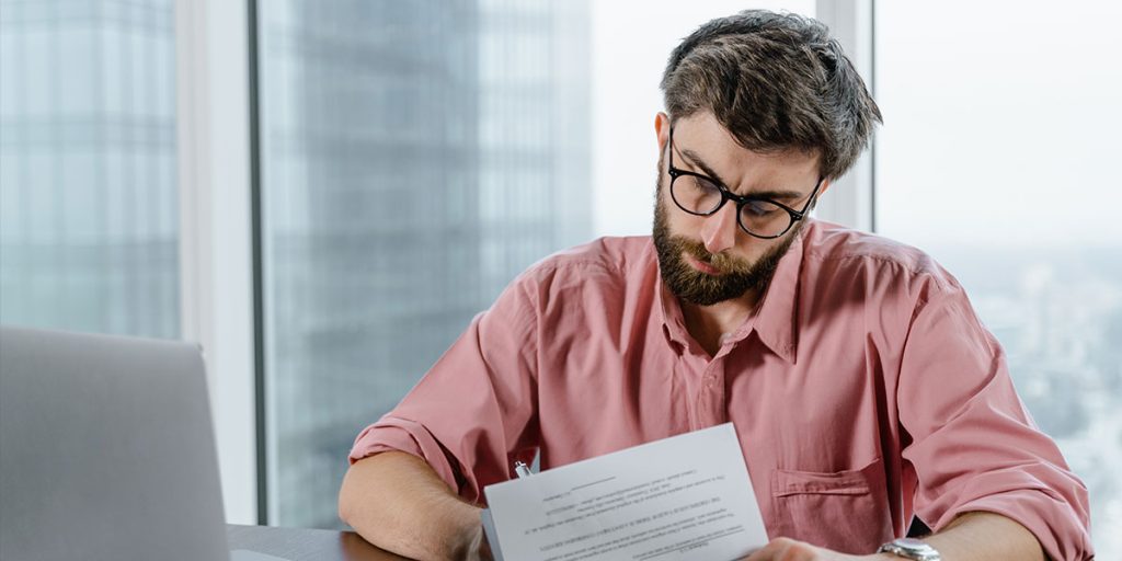 A man checking documents before making a decision to setup SMSF